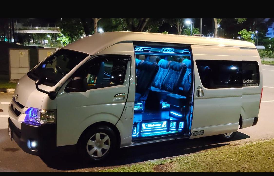 Palani Trading’s white minibus, with the passenger door open and blue cabin lighting